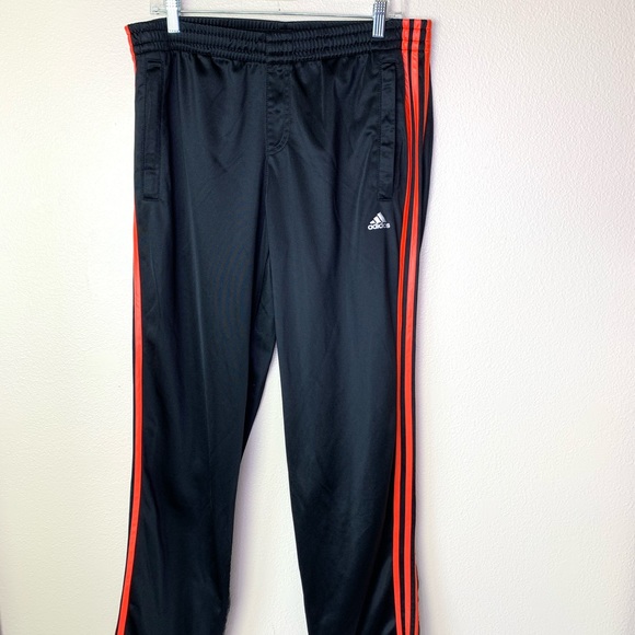 black adidas pants with orange stripes